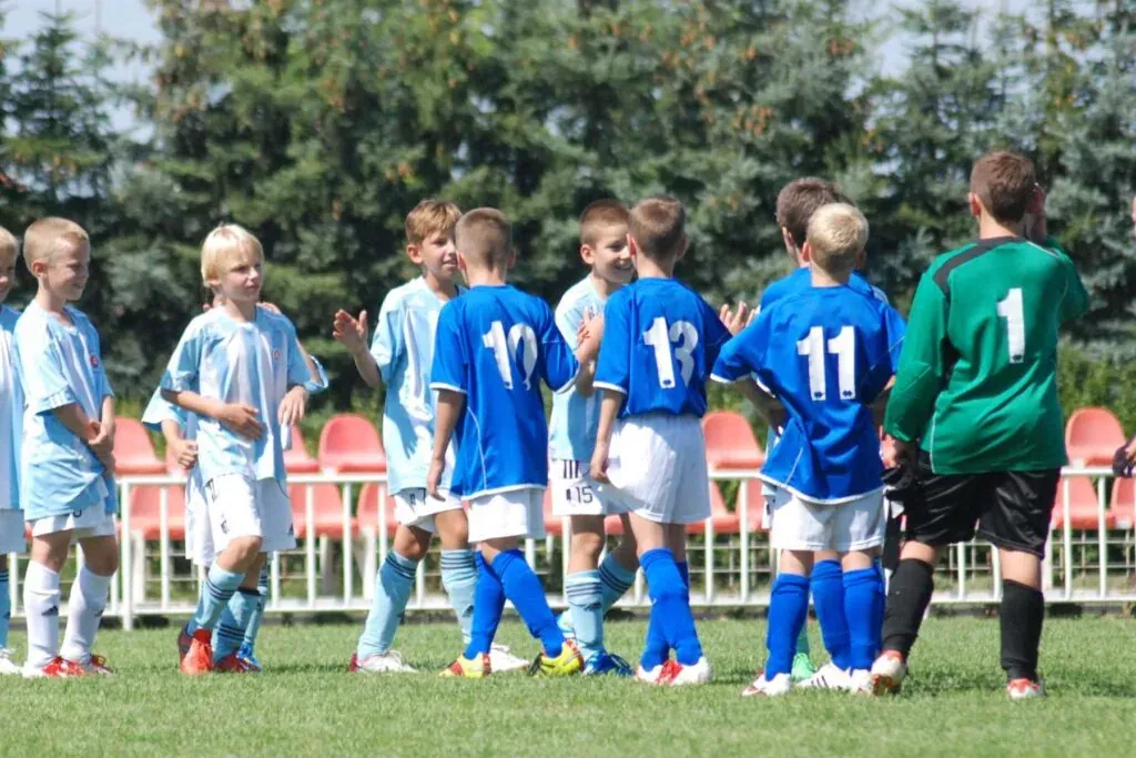 A child expressing disappointment calmly after losing a game at home.