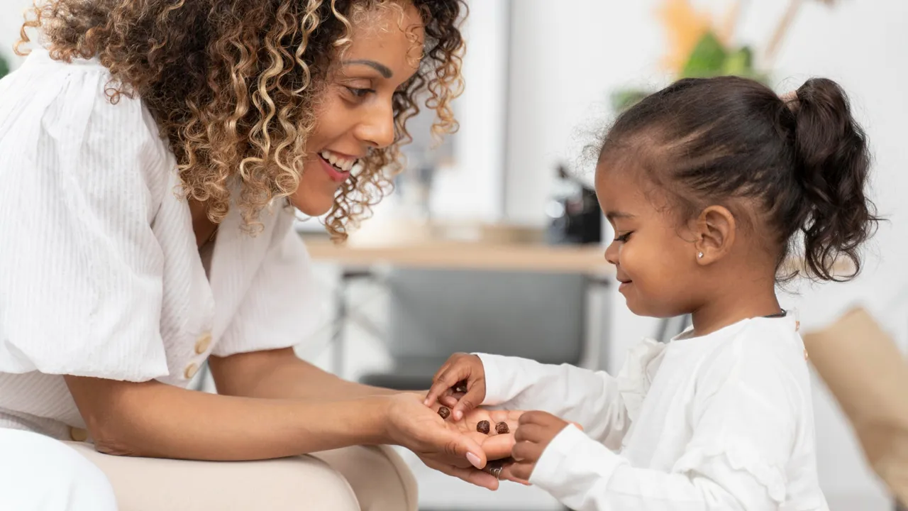 A parent gently gaining a child's attention to help them follow instructions better.