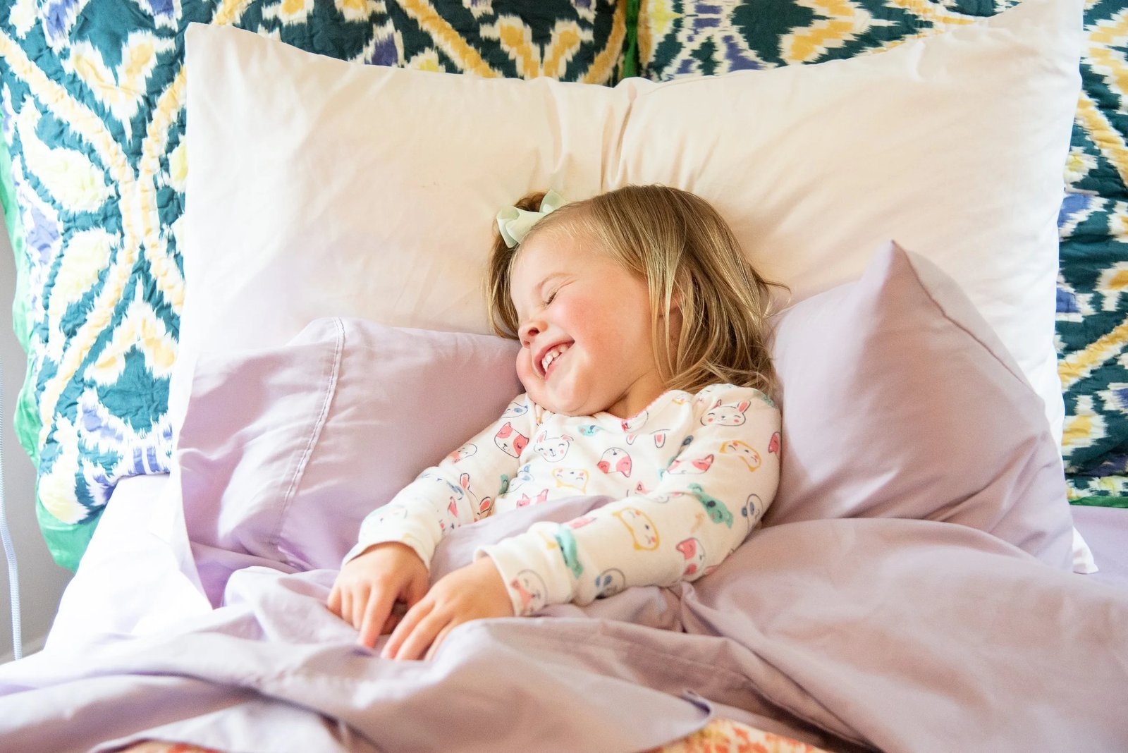 A peaceful toddler sleeping soundly in bed signifying success in bedtime routines.