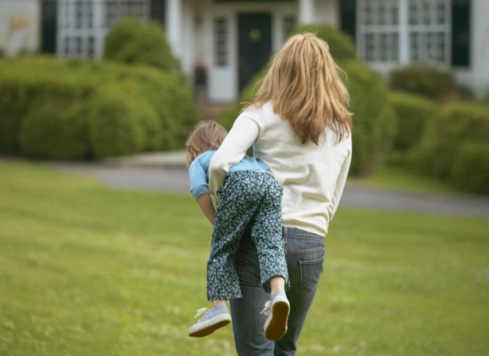 A calm parent modeling emotional regulation while a toddler has a public tantrum.